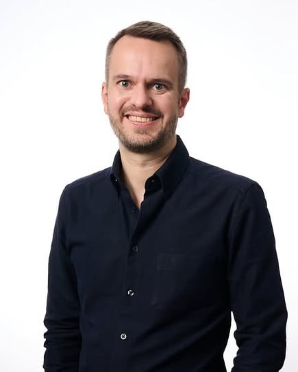 Christian Freese, smiling, in a dark navy shirt