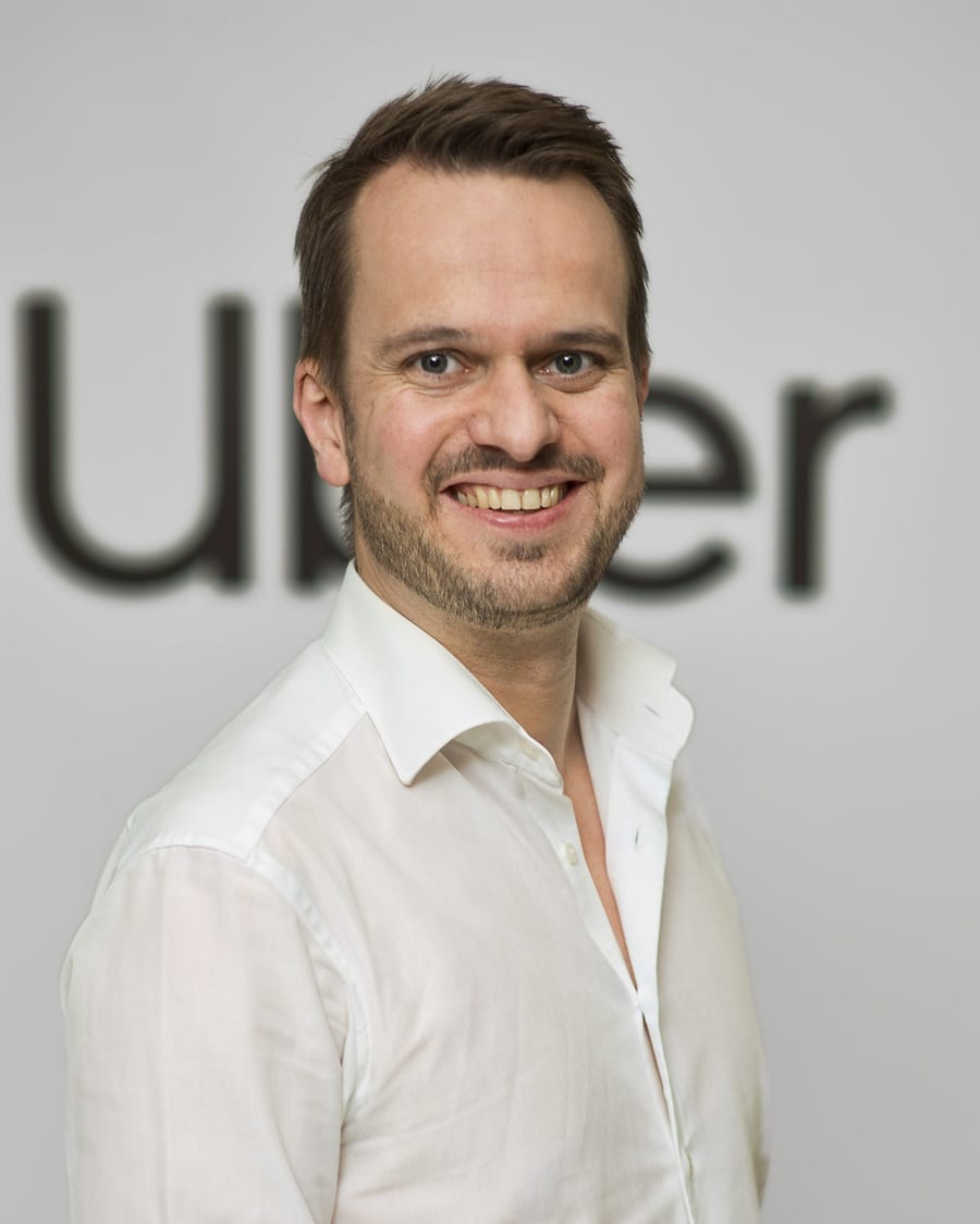 Christian Freese at Uber, in front of the Uber wordmark